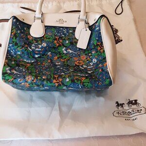 Coach purse, medium size, white with floral pattern.